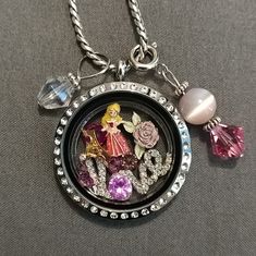 Pre-Owned. Origami Owl Disney Aurora Sleeping Beauty Locket Set. Excellent Used Condition. The Charms Are Brand New. Origami Owl Large Hinged Silver Locket With Crystals, Origami Owl Silver Necklace, Origami Owl Crystal Love Insert, Origami Owl Aurora, Crown & Rose Charms And Six Pink Crystals. **2 Free Dangle Charms- Includes An Iridescent Clear Bead And Pink Beads Silver Dangle Charms To Put On Necklace. The Dangle Charms Are Not Origami Owl. As Pictured.** #A330 Disney Sterling Silver Jewelry In Silver, Silver Disney Charms Jewelry, Disney Silver Charms Jewelry, Disney Silver Jewelry With Charms, Disney Style Silver Jewelry With Charms, Disney Silver Jewelry For Birthday, Disney Silver Jewelry For Anniversary, Personalized Disney Silver Jewelry, Pink Disney Jewelry For Gift