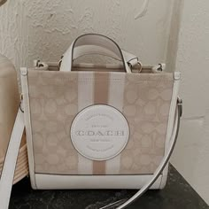 Coach Tote Bag In Great Used Condition Has Some Minor Wear On The Bottom ( Second Picture) But Can Be Cleaned Detachable Strap Measurements: Length: 8.75" Height: 6.25" Width: 4.25" Chic Cream Coach Shoulder Bag, Chic Beige Coach Shoulder Bag, Coach White Large Capacity Shoulder Bag, Coach Double Handle Canvas Bag, Chic Cream Coach Bag, Coach Canvas Bags With Double Handle, Coach Beige Shoulder Bag With Dust Bag, Coach Canvas Bag With Double Handles, Coach Canvas Tote Shoulder Bag