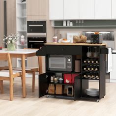 a kitchen with a table, oven and microwave in it's center island next to a dining room table