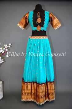 This Dark Sky Blue and Brown Gadwal Silk Lehenga exudes elegance and sophistication with its intricate embroidered borders. The luxurious Gadwal silk fabric adds a touch of luxury, while the Net Embroidered Dupatta completes the look. Perfect for any special occasion, this lehenga offers a timeless and refined style. Traditional Full-length Embroidered Lehenga, Fitted Floor-length Lehenga With Embroidered Border, Embroidered Full-length Fitted Lehenga, Full Length Embroidered Fitted Lehenga, Embroidered Fitted Full-length Lehenga, Fitted Sets With Embroidered Border For Festive Occasion, Fitted Festive Sets With Embroidered Border, Traditional Full-length Lehenga With Zari Work, Floor-length Embroidered Sets For Navratri