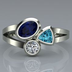 three stone ring with blue and white diamonds