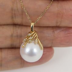 Lovely "In-House' designed pendant, made of solid 14K yellow gold with six- earth mined small accent diamonds and a organic natural "white" Edison cultured pearl.    The enormous 15.2 x 16.5mm pearl exhibits an excellent high luster and thick nacre with just a minimal, mild natural birthmarks; refer to the photos of the actual pendant for detail. Style:  Pendant Precious Metal: Solid 14k yellow gold Genuine Diamond: 6 pcs / 0.030ctw.   --------------------   Pearl:  Freshwater Cultured Pearl Typ Pearl Gold Pendant, Yellow Pearl Necklace, Pearl Pendent Designs, Small Pendent Designs Gold, Pearl Necklace With Pendant, Pearl Pendant Designs Gold, Pearl Pendant Designs, Small Pendants, Dainty Initial Necklace