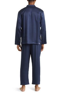 A classic button-up top pairs with matching bottoms in breathable silk pajamas that feel like a dream and can be cleaned in the washing machine. Top has front button closure; long sleeves; chest patch pocket Bottoms have elastic waist; side-seam pockets 100% silk Machine wash, dry flat Imported Blue Sleepwear With Button Closure For Loungewear, Blue Sleepwear With Button Closure, Silk Sleepwear For Pajama Party, Silk Long Sleeve Sleepwear For Home, Silk Sleepwear For Loungewear In Relaxed Fit, Silk Sleepwear Relaxed Fit For Loungewear, Blue Silk Sleepwear For Pajama Party, Long Sleeve Sleepwear With Button Cuffs For Loungewear, Long Sleeve Sleepwear With Button Cuffs