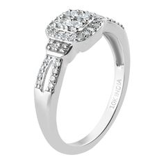 a white gold ring with diamonds on the sides and an oval center stone in the middle