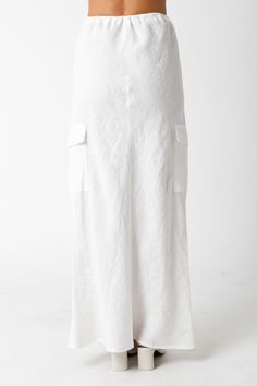 The Kaia White Linen Cargo Maxi Skirt is the perfect vacation cover-up! White linen woven fabric shapes this cargo maxi skirt with a mid-rise fit and drawstring tie. Style with sandals and a cute top and wear to dinner! DETAILS & FIT Loose Fit. 100% Linen. Machine wash cold. Imported. Summer Beach Bottoms With Cargo Pockets, Linen Lined Skirt For Vacation, Relaxed Linen Maxi Skirt For Vacation, Linen Long Skirt For Vacation, Long Linen Skirt For Vacation, Vacation Wide Leg Maxi Skirt For Beach Season, Vacation Beach Maxi Skirt Wide Leg, Vacation Long Linen Skirt, Spring Beach Bottoms With Cargo Pockets