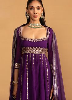 Embrace the beauty and grace with the Purple Embroidered Anarkali Set, crafted from luxurious georgette. The purple anarkali is exquisitely adorned with intricate gota work and boasts a flowy silhouette that adds grace. Paired with a classic churidar for a streamlined look and completed with a delicate net dupatta, enhancing its traditional charm. Ideal for Mehendi, festivals and wedding guests, this ensemble combines timeless style with contemporary sophistication, making it a must-have addition to your collection. Composition : Anarkali - Georgette, Churidar - Semi Crepe and Dupatta - Soft Net Care: Dry Clean Only and Vacuum Storage This product can be customized for sleeves, length and colour Delivery : 4-6 weeks as the product is hand crafted. Check Size Guide or choose MySize for free Elegant Purple Salwar Kameez With Gota Work, Elegant Purple Anarkali Set With Gota Work, Purple Anarkali Style Sharara With Cutdana, Designer Purple Choli With Gota Work, Purple Lehenga With Gota Work For Eid, Purple Gota Work Dress For Eid, Purple Gota Work Dress For Designer Wear, Purple Sharara With Gota Work For Party, Elegant Purple Anarkali Set With Cutdana