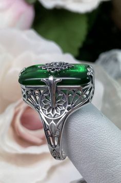 Emerald Green Stone Glass & CZ Ring Grace Design#233 Custom Made I now offer this lovely Antique Art Deco/Edwardian design ring in sterling silver. This gorgeous ring is set with a stunning floral filigree embellished deep emerald green glass/resin with a centered set 1mm white Cubic Zirconia (CZ). The emerald color glass/stone is 18mm Long by 19mm Wide. The ring sits 19mm North South on the finger and 10mm East West on the finger. The inside of the band is marked 925 for sterling. Notice th Polished May Birthstone Jewelry For Weddings, Elegant Silver Emerald Ring Collectible, Green Sterling Silver Art Deco Jewelry, Art Deco Silver Emerald Jewelry, Art Nouveau Sterling Silver Wedding Rings, Victorian Silver Jewelry With Emerald Cut, Victorian Silver Emerald Cut Jewelry, Silver Gemstone Jewelry In Art Nouveau Style, Victorian Emerald Cut Silver Jewelry