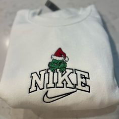 Not Nike Brand Please Allow Up To A Week To Ship Design Size Is 7x5 -Unisex Sizing True To Fit -Embroidered Design -Use Gildan Brand For Crewnecks, However There May Be A Substitute For A Similar Brand -Available In S, M, L, Xl, 2xl Size Of Design Is The Same For All Sizes Of Crewnecks So Design Will Look Smaller On A 2xl Compared To A S Material Is 50/50 Cotton/Polyester *Colors May Vary Slightly* Christmas White Embroidered Tops, White Top With Embroidered Logo For Christmas, White Tops With Embroidered Logo For Christmas, White Tops With Custom Embroidery For Christmas, White Christmas Tops With Embroidered Graphics, Cute Nike Sweatshirts, Nike Embroidery Sweatshirt, Custom Nike Sweatshirt, Custom Nike Hoodie