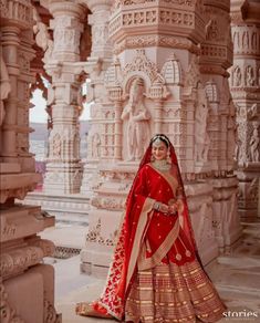 a woman in a red and gold lehenga