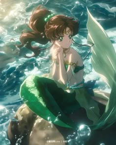 a mermaid sitting on top of a rock in the ocean