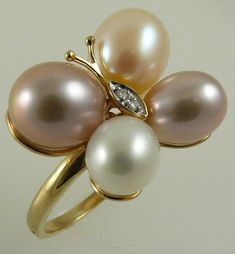 Sku # - 5072 Multicolor Freshwater Pearl Ring Total Number of Pearl = 4 Pearl MM Size = (Peachy Pink) 9.8mm x 8.5mm, (Dark Pink) 9.5mm x 8.7mm (White) 8.2mm x 7.5mm, (Dark Pink) 8.5mm x 7.4mm Shape of Pearl = Oval Color of Pearl = Multicolor Total Number of Diamonds = 2 Total Diamond Weight = 0.02ct Gold = 18k Yellow Gold Total Gram Weight Including Stone = 6.3 Grams Length in Inches = 0.65 of an Inch Width in Inches = 0.80 of an Inch Length in MM = 16.8 MM Width in MM = 20.7 MM Luxury Gold Pearl Ring With High Luster, Luxury Unique Pearl Rings, Luxury Yellow Gold Pearl Ring With Single Diamond, Luxury Yellow Gold Pearl Ring, Luxury Yellow Gold Pearl Ring With Polished Finish, Freshwater Pearl Ring, Pearl Design, Sea Pearl, South Sea Pearls