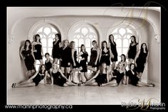 black and white photograph of women posing in front of arched windows