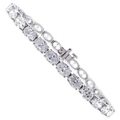 From Pampillonia jewelers, 27 perfectly matched oval diamonds lined up end to end form a straight line of diamonds. The 27 diamonds weigh 11.50 carats and are E-F color and are VS2+ clarity, set in 18 karat white gold. The bracelet is 6 ¾ inches and is available in any length. Pampillonia custom creates diamond bracelets in a variety of diamond shapes and sizes Luxury Oval Tennis Bracelet In Fine Jewelry Style, Luxury Oval Cubic Zirconia Bracelet, Oval Bracelet Diamond, Luxury Diamond White Oval Diamond Bracelet, Luxury Oval Diamond White Diamond Bracelet, Luxury Oval Tennis Bracelet With Single Cut Diamonds, Luxury Oval Diamond Cut Tennis Bracelet, Luxury Oval Diamond Tennis Bracelet, Diamond Tennis Bracelet With Oval Link And Accents