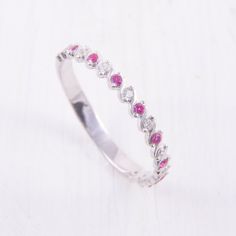 Small Dainty Ruby Wedding Band, Minimalist Wedding Band, Womens Ruby Ring, Ruby Silver Ring, Tiny Wedding Band, Delicate Wedding Band WE OFFER UNLIMITED PERIOD INSTALLMENTS PLAN This is a beautiful, stunning, feminine ring that works well for all occasions, styles, and ages. You will love it! Ring information: Stone: Ruby Approximate size: 1.5mm (9 stones) Stone: White cubic zirconia Approximate size: 1.5mm (9 stones) Metal type: Silver Metal stamp: 925 Sterling Silver Installment Payments We of White Ruby Ring With Prong Setting For Wedding, Elegant Stackable Ruby Wedding Ring, Pink Round Eternity Band For Wedding, Elegant Stackable Ruby Ring For Wedding, Adjustable White Rings For Wedding, Adjustable White Wedding Rings, Dainty Adjustable Wedding Ring, Delicate Silver Birthstone Wedding Ring, Pink Half Eternity Ring For Wedding