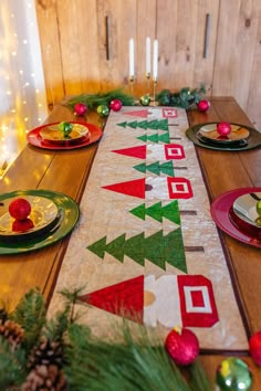 the table is decorated with christmas decorations and plates