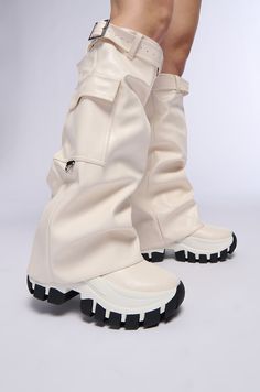 The AZALEA WANG Ezrah White Boot is a flatform sneaker boot hybrid featuring a faux leather upper, a fold-over knee-high shaft, a belted design, and a slightly covered platform rubber lug sole. Complete with functional cargo side pockets, a pull-on fit, and silver metallic hardware accents. (all measurements approximate from a size 7.5) - DenimTextile Upper - Square Toe - Flatform Wedge Sole - 16” Shaft Height - 19” Shaft Opening Circumference - 13” Calf Circumference  - 2.25” Flatform Sole Height - 3” Chunky Heel Height - Imported Product ID: 387453 Cyberpunk Boots, Futuristic Boots, Festival Boots, Fold Over Boots, Silver Platforms, Flatform Sneakers, Animal Shoes, Azalea Wang, Wing Shoes