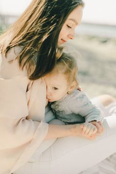 a woman holding a baby on her lap