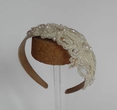 Bridal ivory satin (polyester) headband - a variety of different pearls, beads, sequins and embroidery threads have been used to create a well proportioned diamond shaped motif measuring 20 cm long and 8.5 cm wide.   Can also be made with plain birdcage veil (add £8 to price) or birdcage veil with scattered pearl (add £10 to price). Postage & packaging fee includes elegant hat box. As each hat is made individually to order it is not possible for me to take returns.  Do get in touch if you have any questions. Matching  sash/belt available (see my shop) Elegant Lace Hair Accessories With Matching Headband, Elegant Adjustable Lace Headband, Elegant Lace Adjustable Headband, Handmade Fitted Wedding Headpieces, Silver Embellished Headpiece For Wedding, White Lace Headband For Party, Silver Embellished Wedding Headpiece, White Lace Party Headband, Elegant Lace Hair Accessories With Adjustable Fit