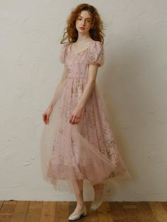 This product is a delicate and charming dress designed to bring a touch of fairy-tale elegance to your wardrobe. It features intricate floral patterns overlaid with a soft mesh fabric, creating a dreamy and ethereal look. The dress is tailored to enhance your feminine silhouette while ensuring comfort and grace for any special occasion. - This dress boasts a soft mesh overlay that adds a whimsical touch to the overall design.- The floral patterns are intricately detailed, offering a timeless and elegant appeal.- It is designed with a flattering silhouette that accentuates the waist and flows gracefully down to the hem.- Perfect for special occasions, this dress ensures both style and comfort with its high-quality fabric and exquisite craftsmanship. Feminine Fairy Wedding Dress, Tulle Fairy Dress For Spring Garden Party, Spring Tulle Fairy Dress For Garden Party, Organza Dress With Floral Print For Evening, Fitted Balletcore Fairy Dress For Spring, Pink Tulle Midi Dress For Spring, Fairycore Tulle Fairy Dress For Garden Party, Elegant Spring Fairy Dress For Wedding, Elegant Fitted Fairy Dress For Garden Party