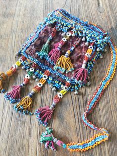 a multicolored beaded purse sitting on top of a wooden table