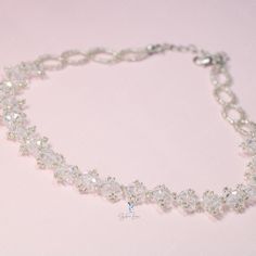 This white crystal bead choker is perfect for cocktail party outfit, wedding party, features shiny white bead with adjustable chain. Add this white rhinestone choker to your everyday fashion jewelry collection or as gift for your love one. Choker length: 13 +2 inches Materials: beads Jewelry Care: See more information about how to care for your jewelry here. Shipping Policy: Orders will be shipped within 1-3 business days. Economy shipping will take 7-14 days to arrive and standard shipping is 1 Adjustable Rhinestone Choker For Formal Occasions, Adjustable White Cubic Zirconia Necklaces, Adjustable White Cubic Zirconia Necklace, Silver Choker With Round Beads For Party, Silver Round Beads Choker For Party, White Cubic Zirconia Crystal Bracelet For Party, Crystal Rhinestone Choker With Adjustable Chain, White Rhinestone Clavicle Chain Necklace For Party, White Crystal Choker Jewelry