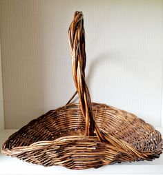 a wicker basket sitting on top of a white shelf