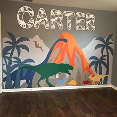 a child's room with dinosaurs painted on the wall and name written in large letters