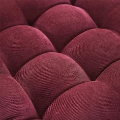 a close up view of a red couch cushion