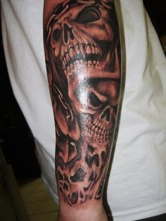 a man with a skull tattoo on his arm