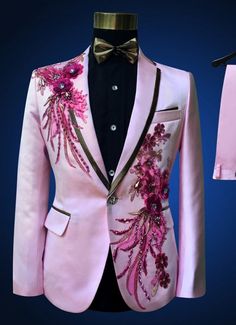 a pink tuxedo with flowers on it is next to a shirt and tie