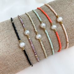 "Add a little Boho Chic to your everyday look with our latest pearl accent beaded bracelets.  Pair them with other bead bracelets, your favorite gold or silver bracelets, or even your watch for the stack of the season. Details:  Miyuki Glass Beads, Freshwater Pearl, Nylon Cord Bracelets expand from 6\" to 10\" A little bit about us: Mom-owned Business Sourcing only the highest quality materials Quick shipping from Colorado" Dainty Adjustable Pearl Bracelet With Tiny Beads, Everyday Pearl Bracelet With Colorful Round Beads, Adjustable Beaded Pearl Bracelets With Pearl Charm, Adjustable Beaded Pearl Bracelet With Pearl Charm, Adjustable Pearl Bracelet With Letter Beads, Everyday Beaded Bracelets With Pearl Charm, Everyday Beaded Bracelet With Pearl Charm, Elegant Tiny Beads Friendship Bracelets For Beach, Adjustable Dainty Pearl Bracelet With Round Beads