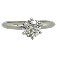 a white gold ring with a round brilliant diamond