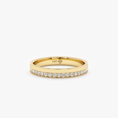 a yellow gold band with white diamonds