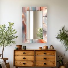 a wooden dresser topped with a mirror next to potted plants