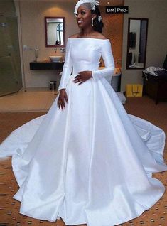 a woman in a white wedding dress posing for the camera