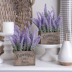 two wooden planters with lavender flowers in them on a shelf next to a basket