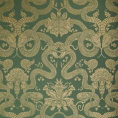 a green and gold wallpaper with an intricate design on it's side,