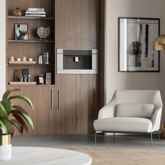 a living room filled with furniture and a white chair in front of a wall mounted oven