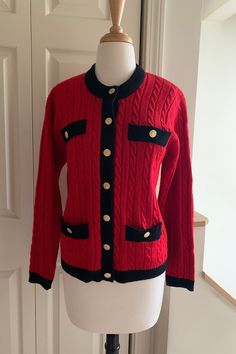 Wonderful classic fully-fashioned Chanel-style sweater jacket. 48% wool, 52% acrylic. Two faux breast pockets, two real buttoned hip pockets. Sleeves have finished tab and button detail. Cable and wide rib stitch patterning, size Medium.  Dimensions: Body 36" circumference  Shoulder width 15 1/2" Length shoulder to hem 23 1/2" Sleeve length 22 1/2" Retro Fall Sweater For Workwear, Retro Workwear Sweater For Fall, Retro Fall Sweater For Work, Classic Winter Cardigan With Snap Buttons, Fitted Button-up Sweater With Pockets, Classic Knit Outerwear With Pockets, Classic Knit Sweater Coat, Formal Winter Cardigan With Buttons, Classic Snap Button-up Sweater