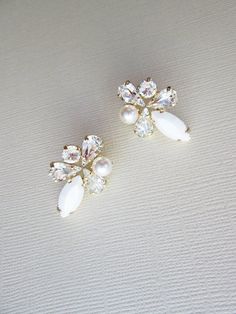 "These fun sparkly earrings are made with fine Swarovski crystals in chalk white and clear crystal mix and Swarovski crystal white pearls. Post earrings with butterfly ear-nuts. Available in gold, silver or rose gold finish. - measurements : 1\" long and 3/4\" wide" White Crystal Embellished Bridal Earrings For Party, White Sparkling Cluster Earrings With Cubic Zirconia, White Cubic Zirconia Cluster Earrings For Party, Sparkling White Cubic Zirconia Cluster Earrings, White Cubic Zirconia Party Earrings, White Rhinestone Bridal Earrings For Formal Occasions, White Crystal Embellished Earrings For Party, White Pearl Crystal Earrings, White Bling Crystal Earrings For Wedding