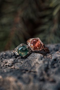 two rings sitting on top of a rock