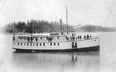 a large white boat floating on top of a lake