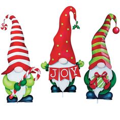 three christmas gnomes standing next to each other