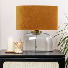 a table with a lamp and a vase on it