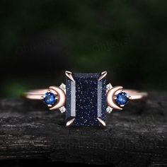 "This is a  Lab blue sandstone engagement ring in solid gold,about 6X8mm emerald cut. The accent stones are lab sapphires and moissanites. The band width is about 1.3mm. It can be made in any ring size. However please contact me to custom make it to a special big or small size. It can be made in white gold,rose gold or yellow gold with 14k or 18k. However for some people who are nickel allergic,I can also make it to 925 sterling silver to make you can wear it. The ring is handmade,very high quality! 30 days money back guarantee. Returns & Warranty 30-Day money back guarantee (starting from the day of delivery). \"Made to Order\" purchases qualify for our 30-day money back guarantee. The 30-day money back guarantee gives you time to make sure your purchase is perfect. If you need to  return Celestial Style Rose Gold Ring, Sapphire Princess Cut Promise Ring Jewelry, Sapphire Princess Cut Jewelry For Promise Ring, Elegant Rose Gold Sapphire Jewelry, Sapphire Rose Gold Ring Jewelry, Rose Gold Emerald-cut Jewelry With Halo Setting, Rose Gold Sapphire Ring Jewelry, Rose Gold Sapphire Round Cut Jewelry, Promise Sapphire Jewelry With Princess Cut