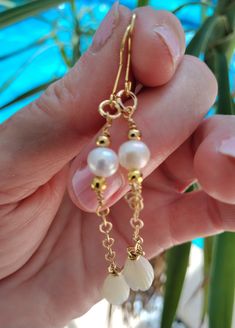 Inspired by traditional Hawaiian leis, this hand made earring set features AAA Natural Freshwater Pearls, gold accent beads, and authentic Natural Mother of Pearl Pikake Beads. The earrings are approximately 3 inches including hook.  These unique beauties are ready for you and your tropical escape. Packaged in a gift box, perfect to give to someone special or to yourself. Complete your beach/resort jewelry with these earrings. These earrings are also  perfect for a beach bride on her special day Yellow Gold Jewelry With Latkans For Anniversary, Dainty Handmade Gold Pearl Earrings, Handmade Delicate Yellow Gold Pearl Earrings, Delicate Pearl Drop Jewelry For Celebration, Delicate Handmade Yellow Gold Pearl Earrings, Handmade Delicate Jewelry For Celebrations, Delicate Handmade Jewelry For Celebrations, Festive Gold Jewelry With Ear Wire, Wedding Yellow Gold Jewelry With Dangling Beads