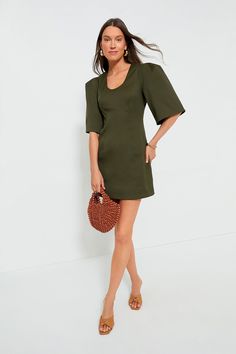 Perfect for drinks, dinners, and brunches alike, the Olive Twill Ariella Dress features an eye-catching silhouette in the color of the season. This fitted mini features half-length bell sleeves with double pleats at the shoulder for shape, and a U-scoop neckline that is perfect for displaying fun necklaces. Pair with heels, ballet flats, or sandals- this beauty goes with anything and everything! U-scoop neckline Half-length bell sleeves with puff shoulders Invisible side zip closure Princess sea Green Puff Sleeve Mini Dress For Evening, Structured Shoulder Mini Dress For Summer, Structured Shoulders Mini Dress For Summer, Spring Cocktail Mini Dress With Structured Shape, Chic A-line Mini Dress With Pleated Sleeves, Spring Mini Dress With Structured Shoulders, Spring Knee-length Mini Dress With Structured Shoulders, Fall Mini Dress With Structured Shoulders, Green Mini Length Puff Sleeve Dress For Brunch