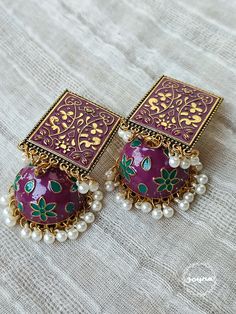 This intricate pair of earrings can be styled with a variety of outfits. They are durable and classy. They can be the highlight of your look.  N.B. The color can slightly differ from the given photos due to lighting. Bohemian Purple Jewelry For Festive Occasions, Traditional Purple Jewelry For Festival, Purple Traditional Festival Jewelry, Bohemian Purple Earrings For Wedding, Elegant Jhumkas For Festive Occasions, Bohemian Tilla Jhumkas For Festive Occasions, Festive Bohemian Bridal Earrings With Latkans, Handmade Bohemian Kundan Jhumkas, Bohemian Kundan Handmade Jhumkas