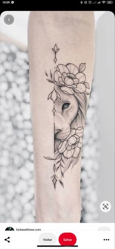 a woman's arm with a lion and flowers tattoo on the left inner forearm