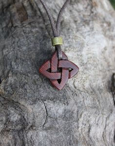 a wooden necklace with a knot on it